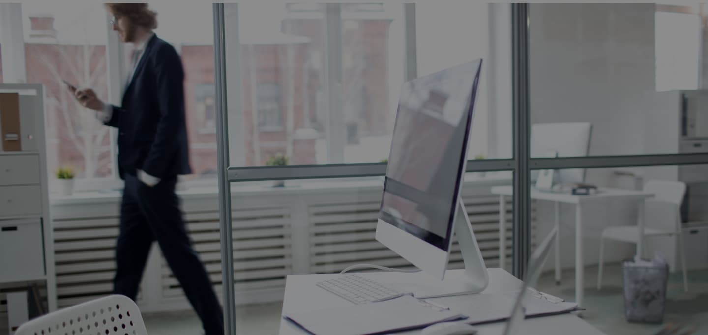 A modern office with professionals collaborating on a project with AI-driven data visualizations on screen.